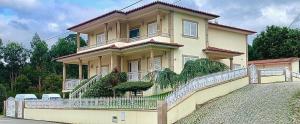 a large house with a fence in front of it at Lux House in Ferreira