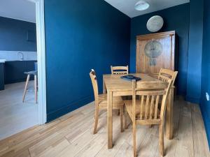 a dining room with a wooden table and chairs at The Cottage At Stanley Villa in Southport