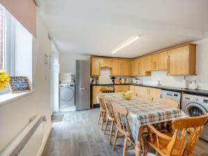 a kitchen with a dining room table and chairs at The Old Jolly in Wainfleet All Saints