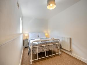 a bedroom with a bed in a white room at The Old Jolly in Wainfleet All Saints +11 photos