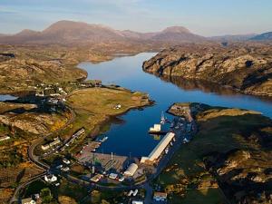 an aerial view of a large river with mountains at The Old Surgery in Kinlochbervie