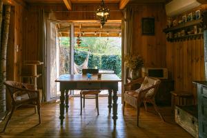 a dining room with a wooden table and chairs at Łosiedlisko in Łosiewice