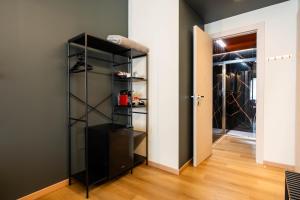 a walk in closet with a black book shelf at TWO Cagliari Charming House in Cagliari