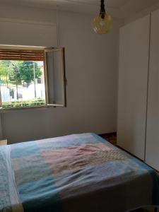 a bedroom with a bed and a window at Demodé Trekking in Madonna di Fornelli