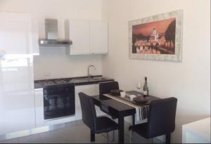 a kitchen with a black table and chairs and a stove at Ara-Home in Aranova