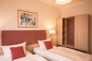 Postel nebo postele na pokoji v ubytování Hotel Leander
