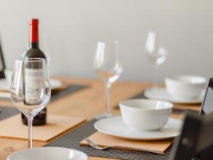 a table with two glasses and a bottle of wine at Court House in Porthcawl +32 photos