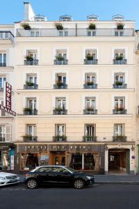 a black car parked in front of a building at Hotel des Bains in Paris