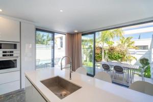 a kitchen with a large window and a table with chairs at Panorama Luxury Summer Villa in Protaras