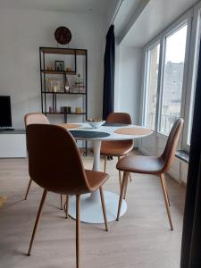 a dining room with a table and chairs at Modern and cozy apartment in Middelkerke