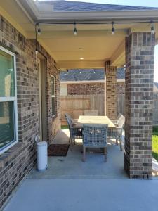 a patio with a table and chairs at Comfortable family house in Hot Wells