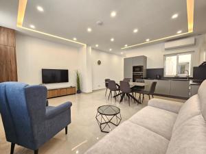 a living room with a couch and a table at SaltWater in St Paul's Bay