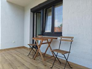 a table and two chairs next to a window at Anna's Residence in Budapest