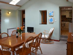 a dining room with a wooden table and chairs at Cowslip - Uk12060 in Lower Boscaswell