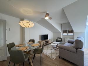a living room with a table and chairs and a couch at Doña Carmen en el corazón Cangas Onís VUT-6783-AS in Cangas de Onís