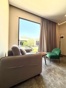 a living room with a couch and a large window at Luna Mare Boutique Seaside in Borsh