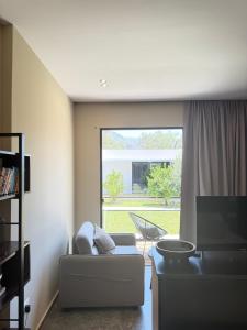 a living room with a couch and a large window at Luna Mare Boutique Seaside in Borsh