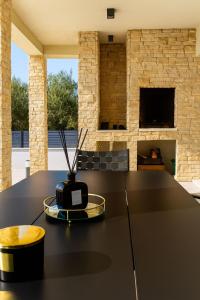 a kitchen with a black table with a vase on it at Villa Adria Maria 2 in Privlaka