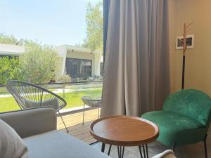 a living room with a couch and a chair and a table at Luna Mare Boutique Seaside in Borsh