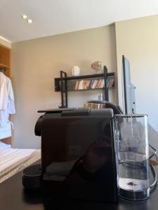 a microwave and a glass of water on a table at Luna Mare Boutique Seaside in Borsh