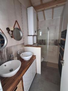a bathroom with two sinks and a shower at Villa Rosso in Clisson