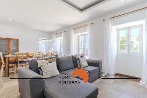 a living room with a couch and a dining room at #331 Casa Chico Rita by Home Holidays in Sesmarias +59 photos