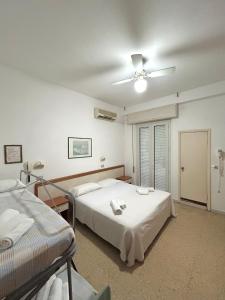Postel nebo postele na pokoji v ubytování Hotel Caracas