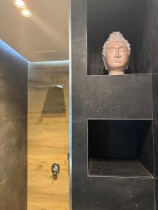 a bust of a head on a wall next to a door at Luna Mare Boutique Seaside in Borsh