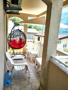 a patio with chairs and a swing on a porch at Apartment Bay View in Kotor +18 photos