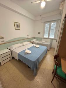 Postel nebo postele na pokoji v ubytování Hotel Caracas
