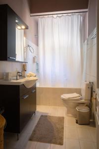 a bathroom with a toilet and a sink and a shower at Dimora - A Spacious Luxury Penthouse in Town's Heart in Corfu Town