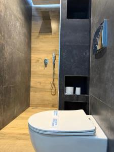 a bathroom with a toilet and a shower at Luna Mare Boutique Seaside in Borsh