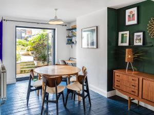 a dining room with a table and chairs at Eaton Beach House in Margate
