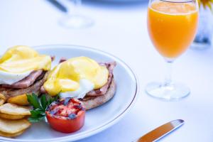 a plate of breakfast food and a glass of orange juice at Sheraton Anchorage Hotel in Anchorage