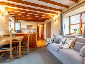 a living room with a couch and a table at Maybeck Cottage in Whitby