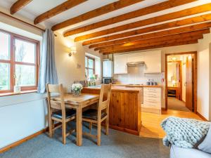 a kitchen with a table and chairs in a room at Maybeck Cottage in Whitby