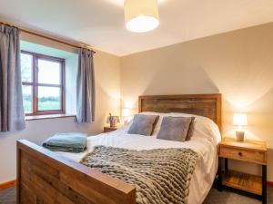 a bedroom with a large bed and a window at Maybeck Cottage in Whitby +9 photos