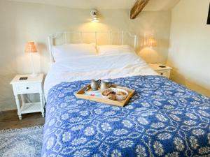 a tray of food on top of a bed at Cobble Cottage in Instow +11 photos