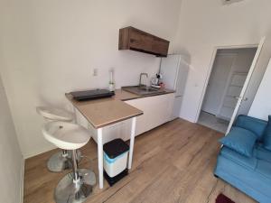 a small kitchen with a table and a blue couch at Maja in Selce