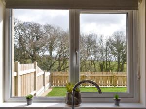 a kitchen window with a view of a fence at Five Dorchester Drive - Uk32043 in Inglewhite