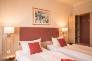 Postel nebo postele na pokoji v ubytování Hotel Leander