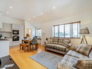 a living room with a couch and a table at The Cottage in Langsett
