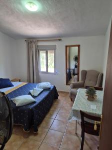 a bedroom with a bed and a couch and a table at beautiful guest room with swimming pool in Gormach +26 photos