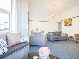 a living room with couches and a table at Salty Towers in Saltburn-by-the-Sea