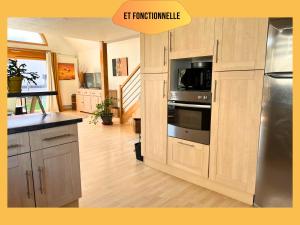 a kitchen with a refrigerator and a microwave at Maison avec jardin - 6 personnes - Top emplacement in Ribeauvillé