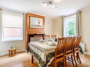 a dining room with a table and chairs at Manager's Cottage in Loddon