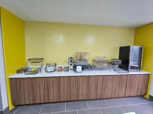 a counter in a room with a yellow wall at Microtel Inn by Wyndham Atlanta Airport in Atlanta