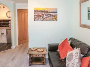 a living room with a couch and a table at Whitby Sands in Whitby