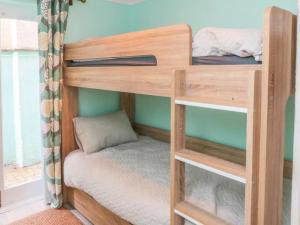 a wooden bunk bed in a room at Whitby Sands in Whitby