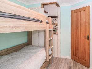 a room with two bunk beds and a door at Whitby Sands in Whitby +8 photos